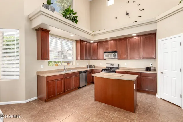 a kitchen with stainless steel appliances granite countertop wooden cabinets a stove top oven a sink and dishwasher
