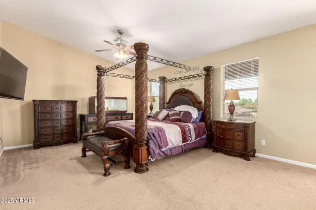 a view of a bedroom with furniture and a flat screen tv