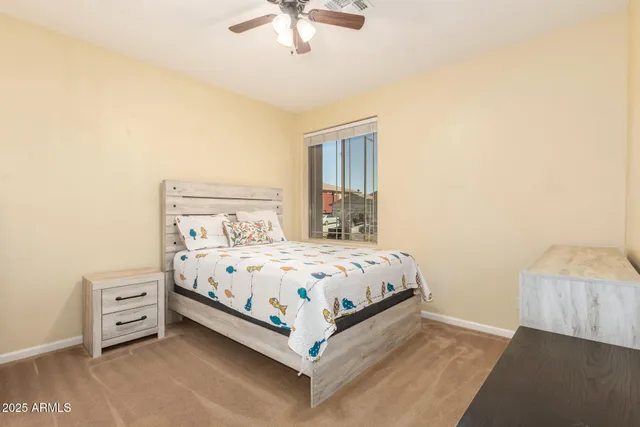 a bedroom with a bed a window and a chandelier