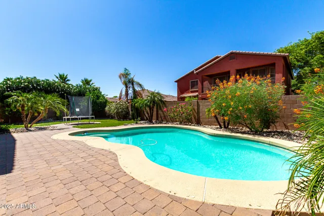 a view of a house with backyard and sitting area