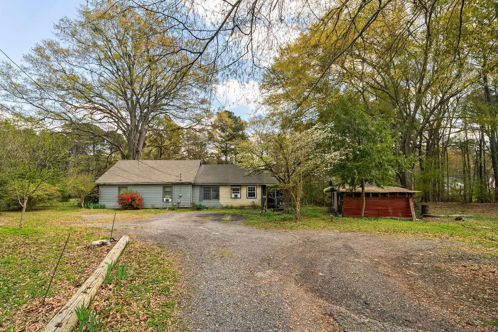 4661 Fowler Street Acworth, GA 30101 - Photo 5 of 23 a view of a house with a yard and large trees