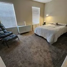 a bedroom with a bed and a desk