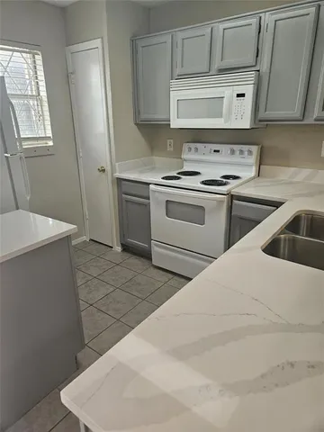a kitchen with a stove and a refrigerator