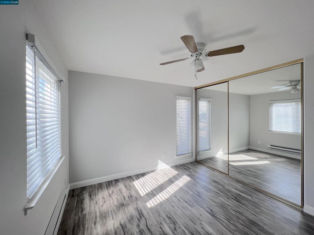 1505 Kirker Pass Road Concord, CA 94521 - Photo 13 of 22 a view of empty room with wooden floor and fan