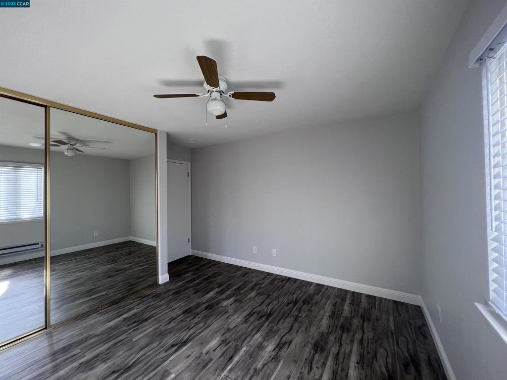 1505 Kirker Pass Road Concord, CA 94521 - Photo 14 of 22 an empty room with wooden floor and windows