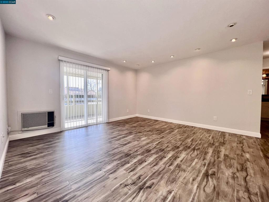 1505 Kirker Pass Road Concord, CA 94521 - Photo 2 of 22 an empty room with wooden floor and windows