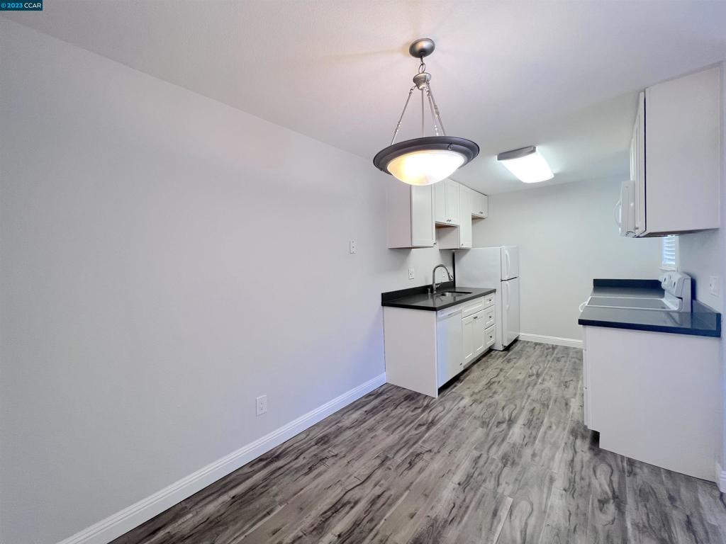 1505 Kirker Pass Road Concord, CA 94521 - Photo 5 of 22 a kitchen with granite countertop a sink a counter space and cabinets