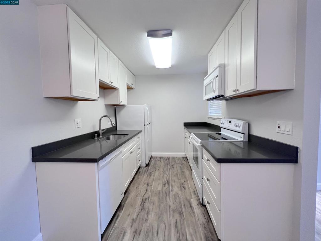 1505 Kirker Pass Road Concord, CA 94521 - Photo 6 of 22 a kitchen with granite countertop a sink a stove and cabinets