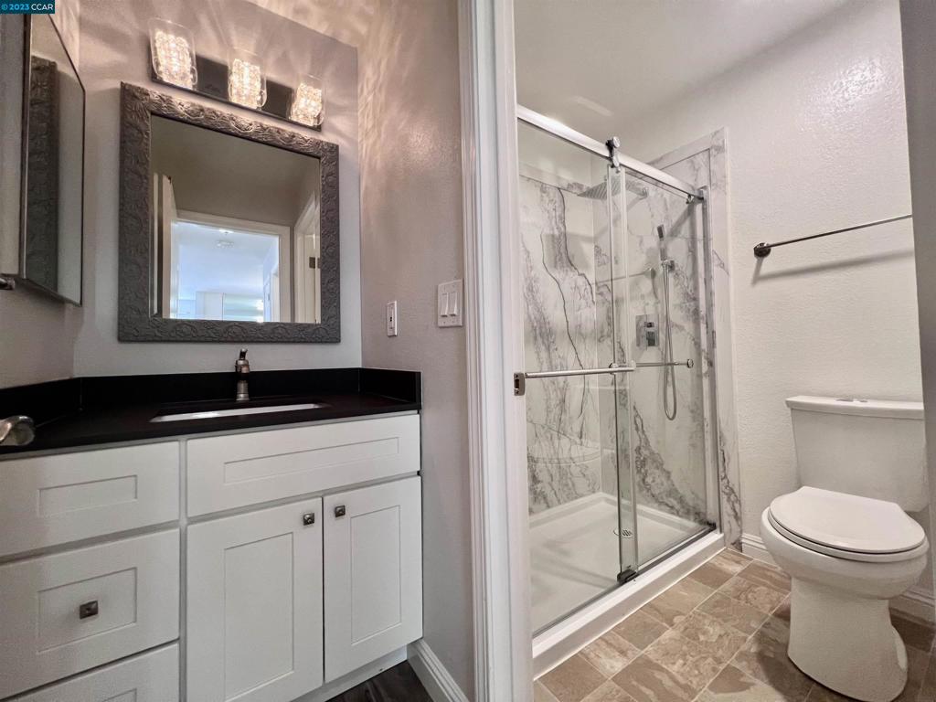 1505 Kirker Pass Road Concord, CA 94521 - Photo 10 of 22 a bathroom with a sink a toilet and shower