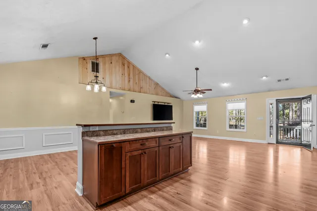 a kitchen with stainless steel appliances a stove top oven a sink and a refrigerator