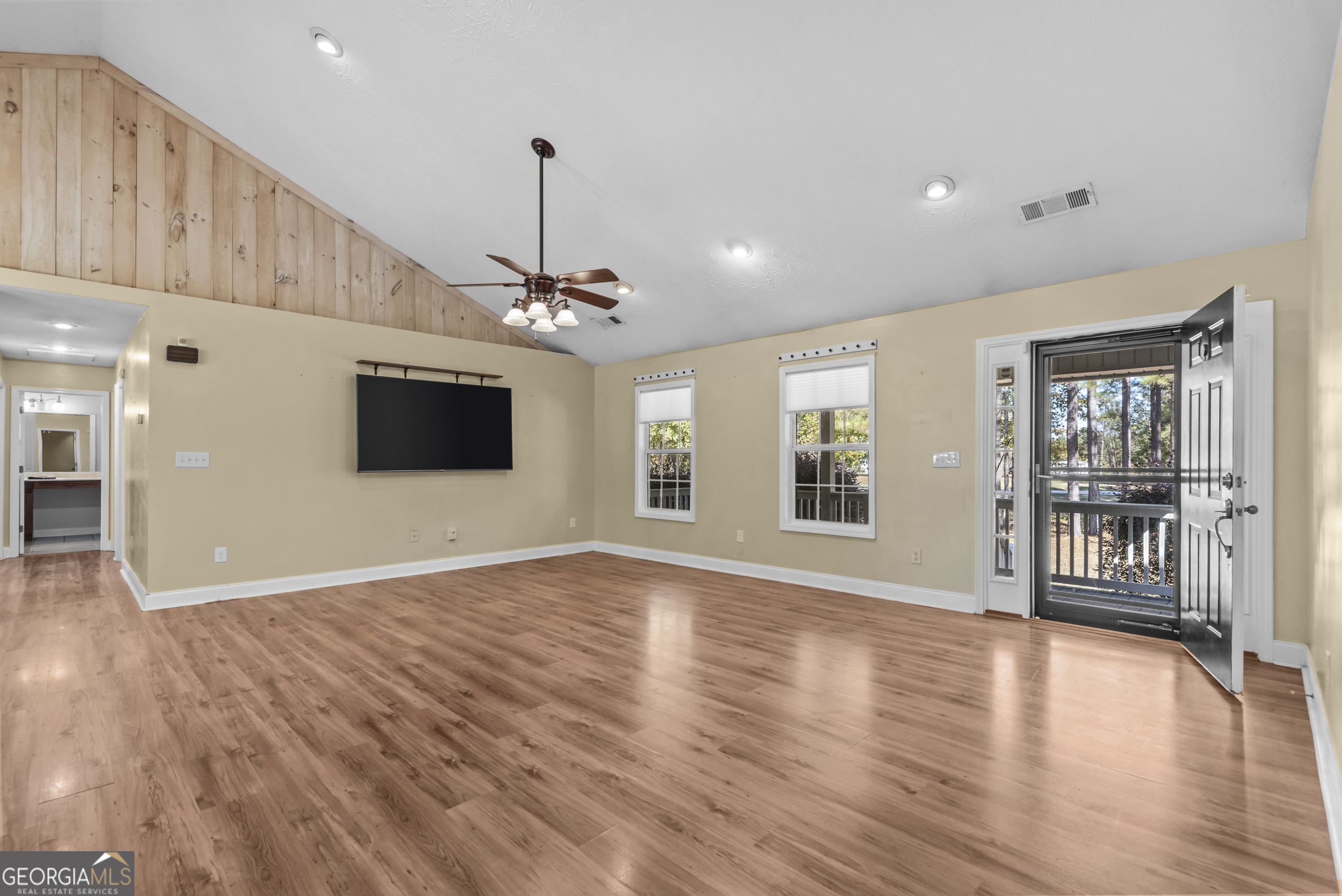384 Scuffleboro Road Southeast Eatonton, GA 31024 - Photo 15 of 48 a view of an empty room with wooden floor and a window