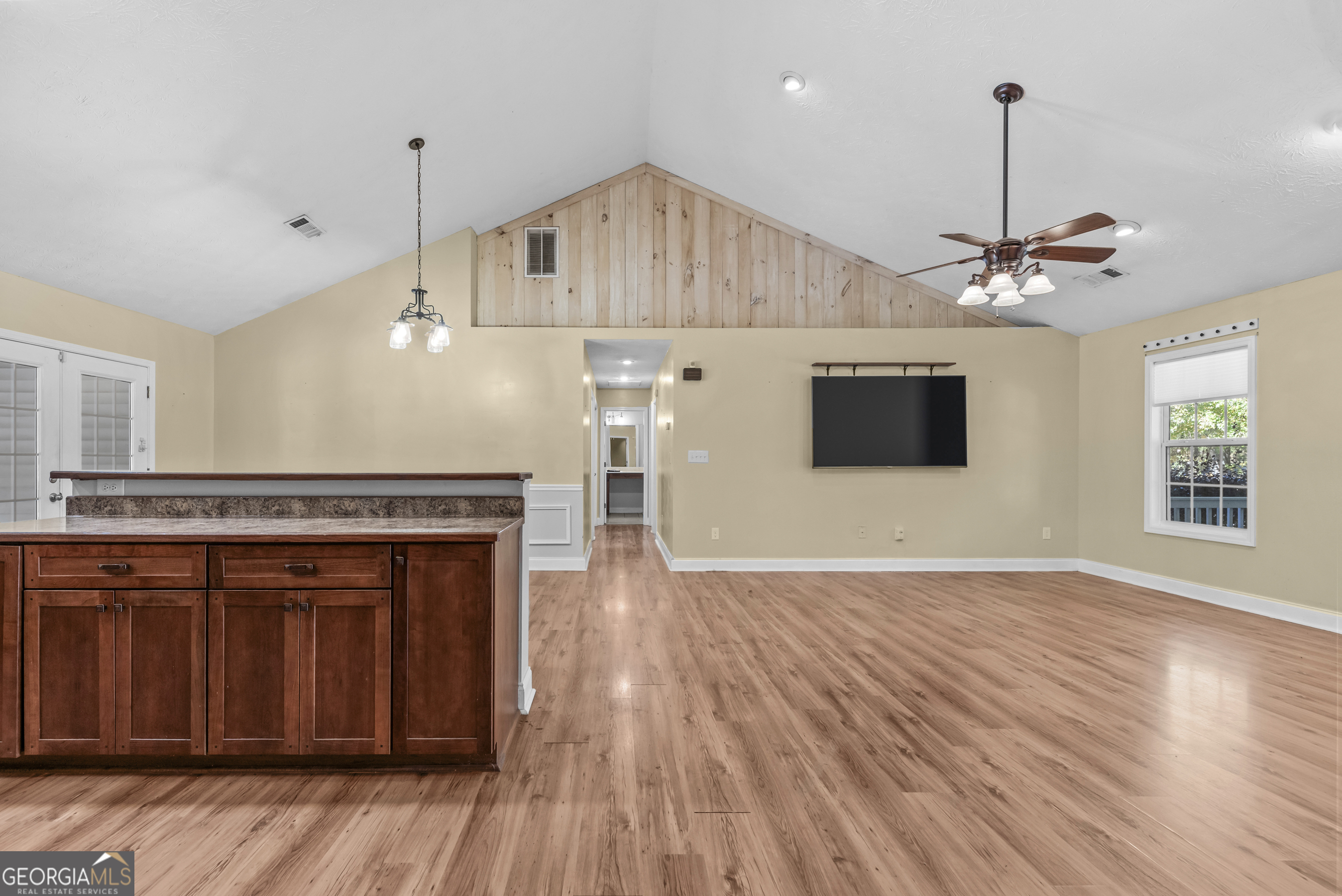 384 Scuffleboro Road Southeast Eatonton, GA 31024 - Photo 16 of 48 a view of a kitchen with a stove wooden floor and a kitchen island