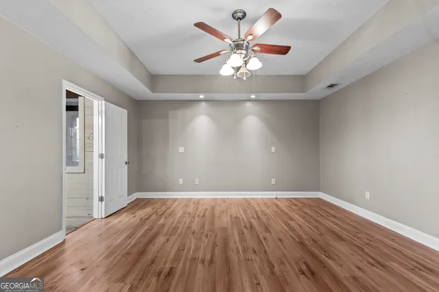 wooden floor in an empty room with a window