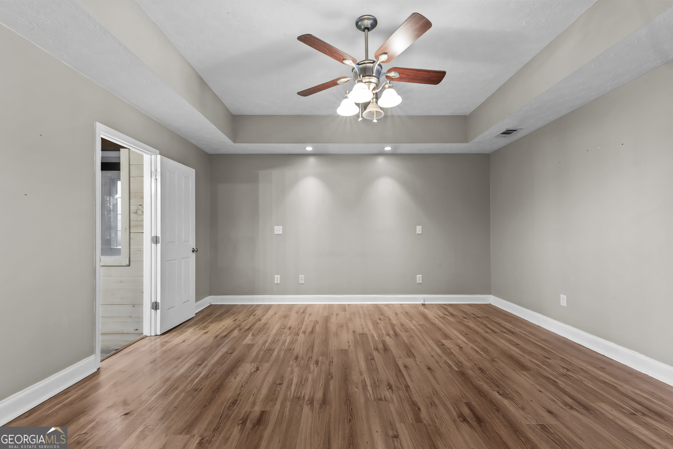 384 Scuffleboro Road Southeast Eatonton, GA 31024 - Photo 17 of 48 wooden floor in an empty room with a window