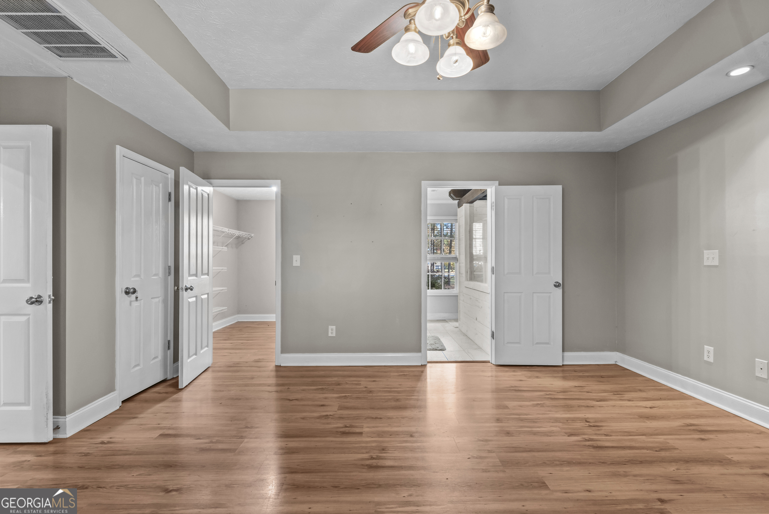 384 Scuffleboro Road Southeast Eatonton, GA 31024 - Photo 18 of 48 a view of an empty room with wooden floor and a window