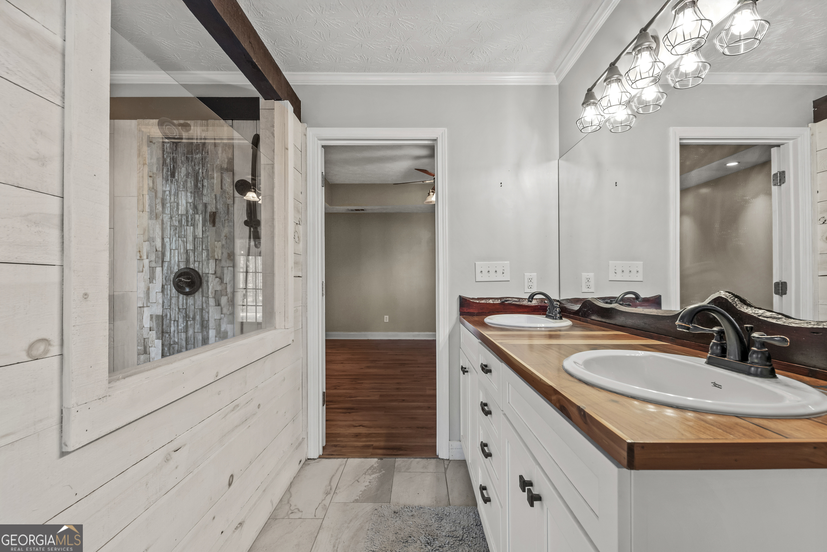 384 Scuffleboro Road Southeast Eatonton, GA 31024 - Photo 22 of 48 a bathroom with a double vanity sink and shower