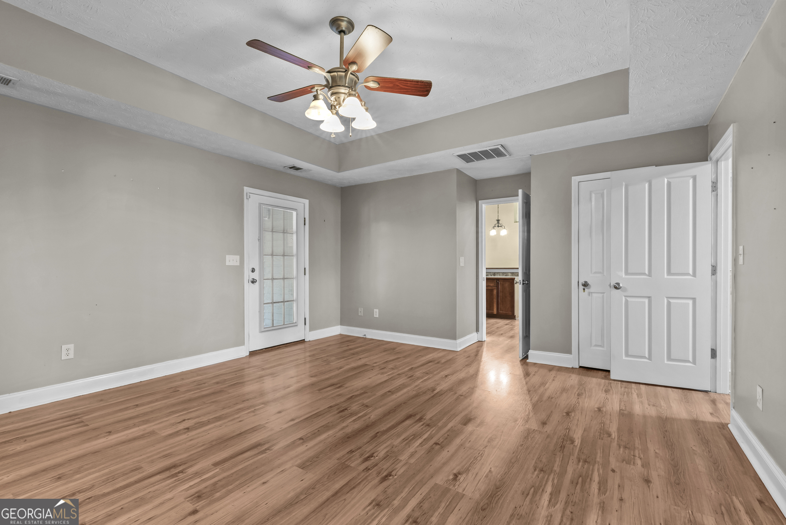 384 Scuffleboro Road Southeast Eatonton, GA 31024 - Photo 23 of 48 a view of an empty room with wooden floor