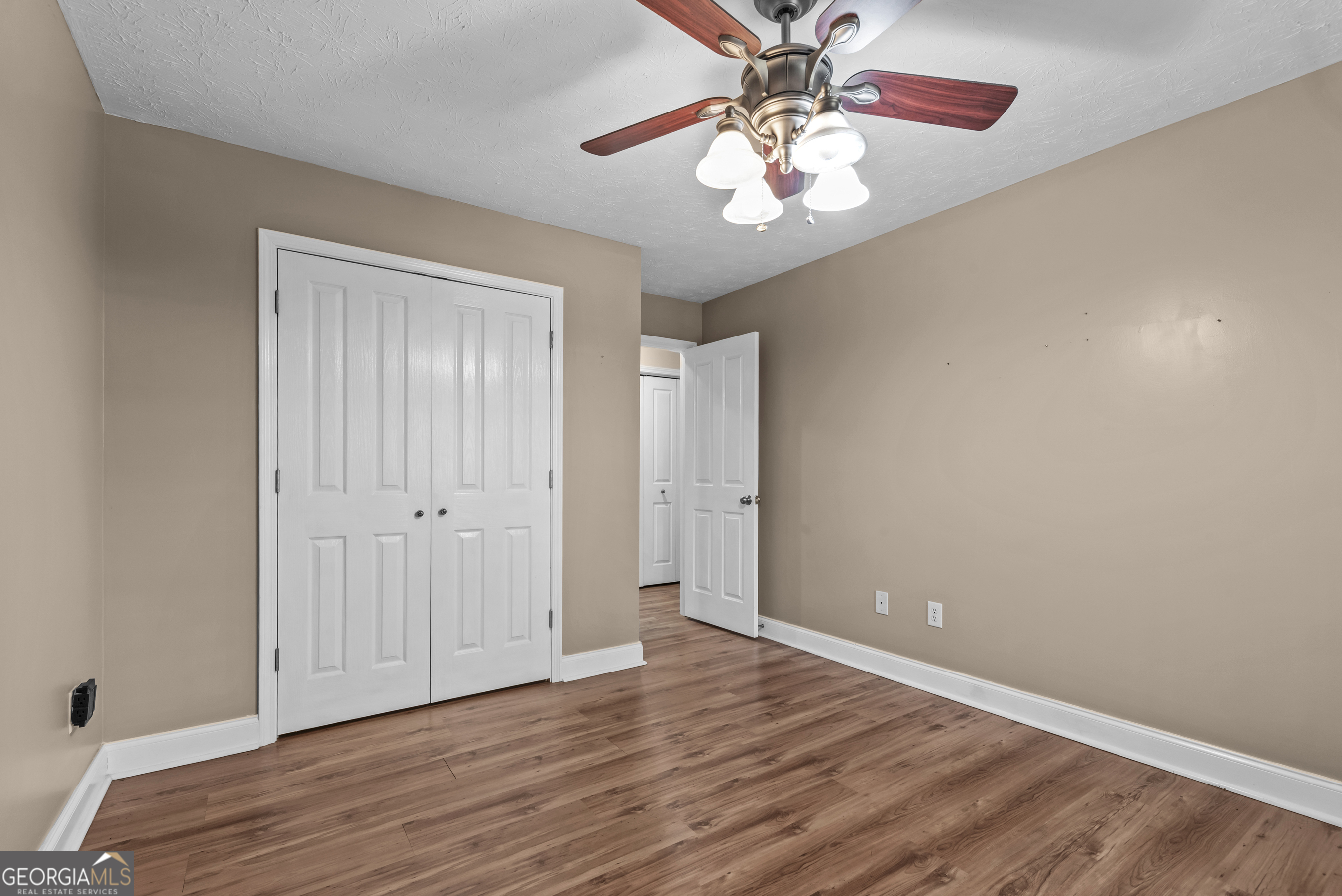 384 Scuffleboro Road Southeast Eatonton, GA 31024 - Photo 25 of 48 a view of an empty room with wooden floor