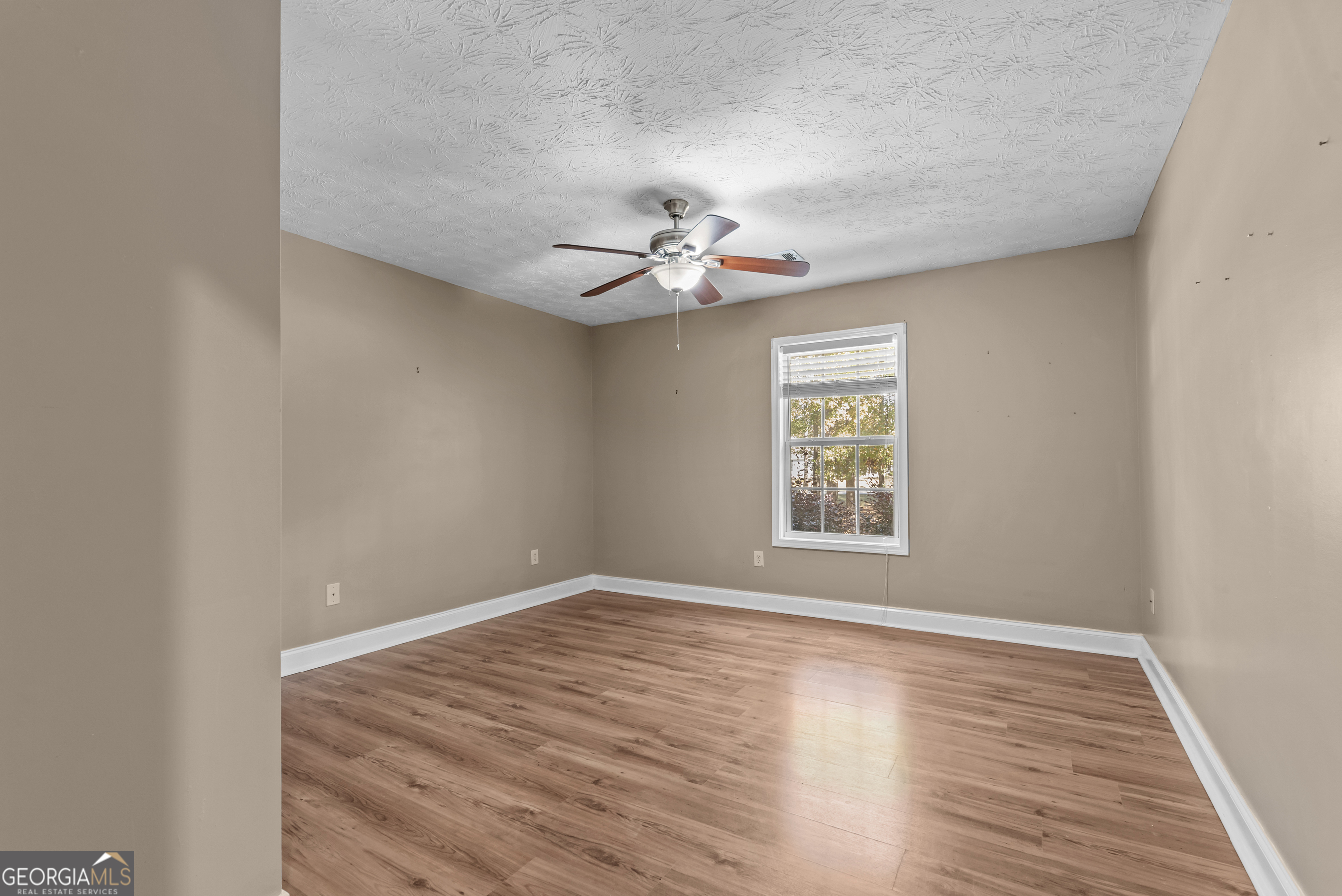 384 Scuffleboro Road Southeast Eatonton, GA 31024 - Photo 26 of 48 wooden floor in an empty room with a window