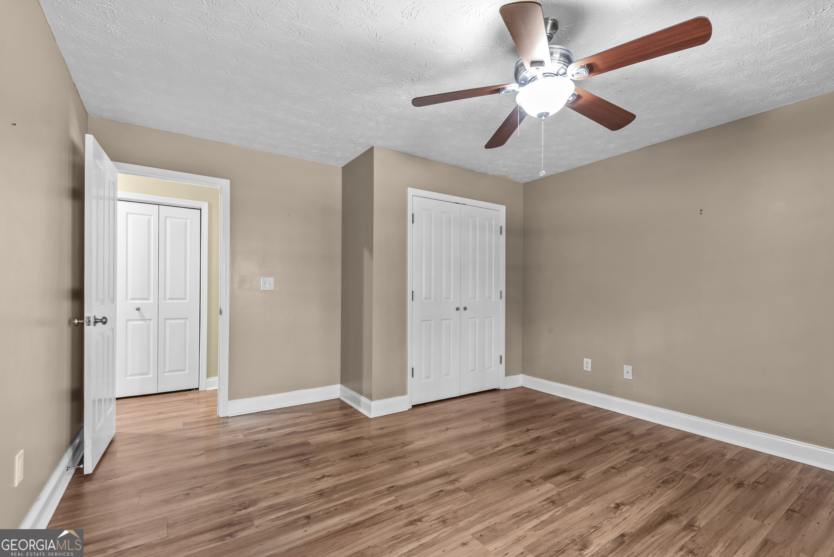 384 Scuffleboro Road Southeast Eatonton, GA 31024 - Photo 27 of 48 wooden floor in an empty room with a window