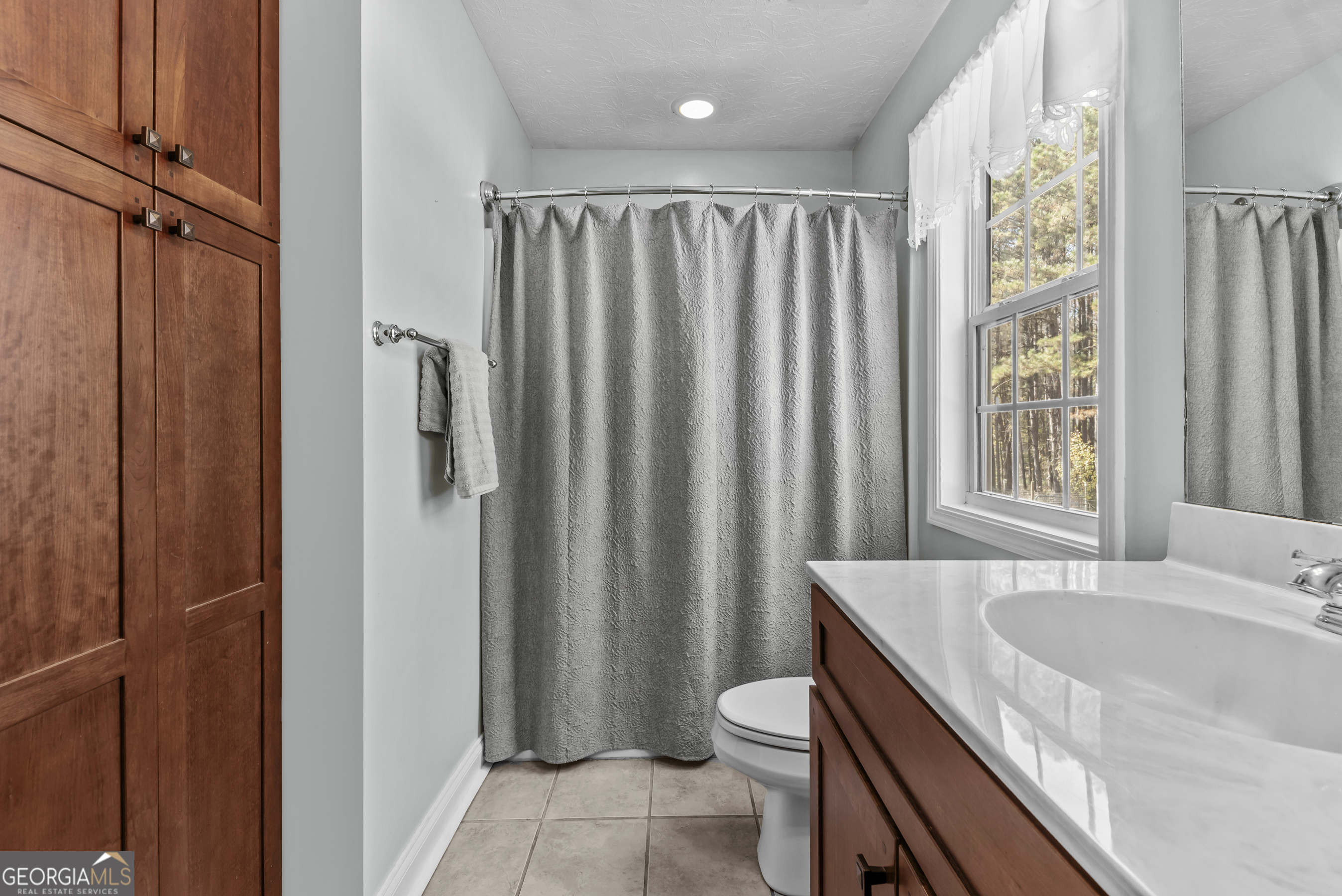 384 Scuffleboro Road Southeast Eatonton, GA 31024 - Photo 28 of 48 a bathroom with a granite countertop sink and a mirror