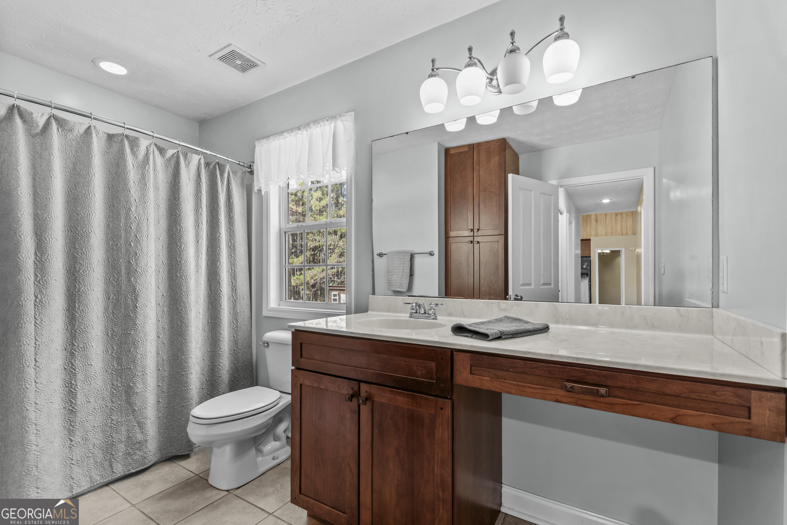 384 Scuffleboro Road Southeast Eatonton, GA 31024 - Photo 29 of 48 a bathroom with a granite countertop sink a toilet and a mirror