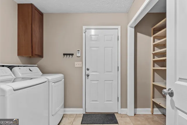a view of bathroom with washer and dryer