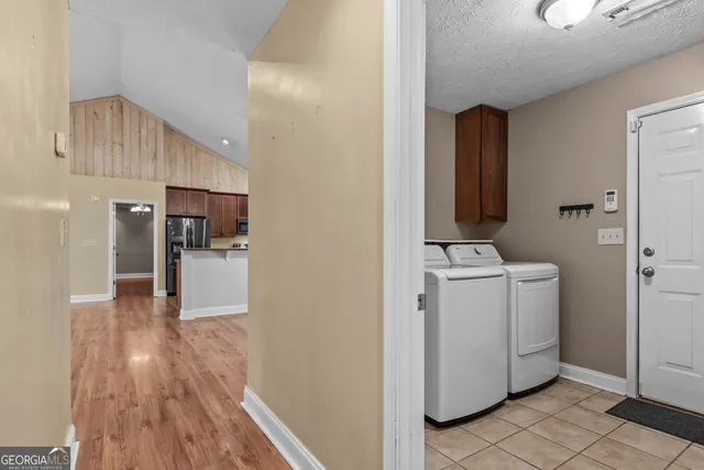 a view of storage and utility room with wooden floor