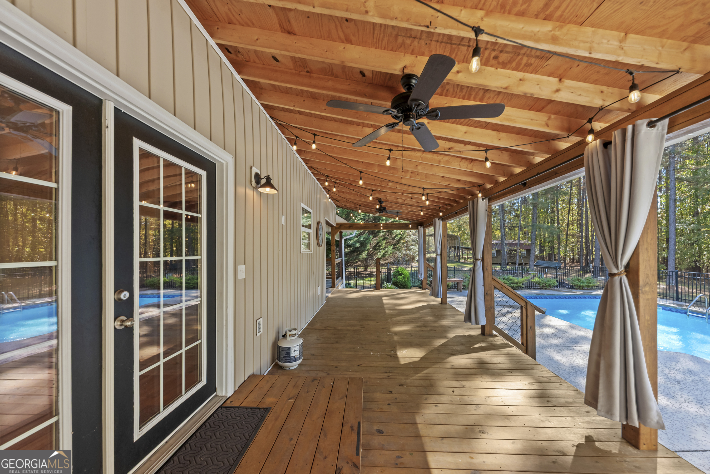 384 Scuffleboro Road Southeast Eatonton, GA 31024 - Photo 36 of 48 a view of a porch with wooden floor and windows
