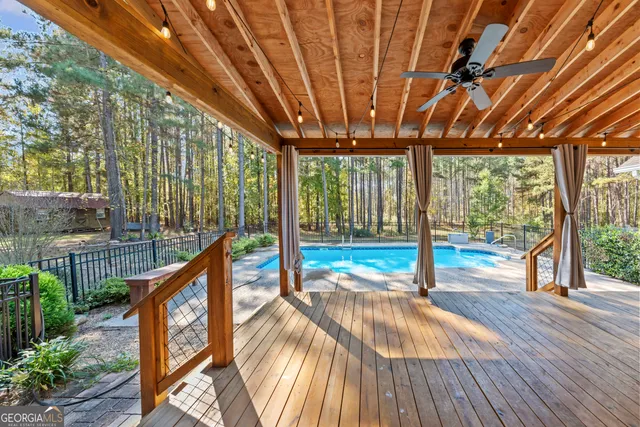 a view of swimming pool with wooden deck