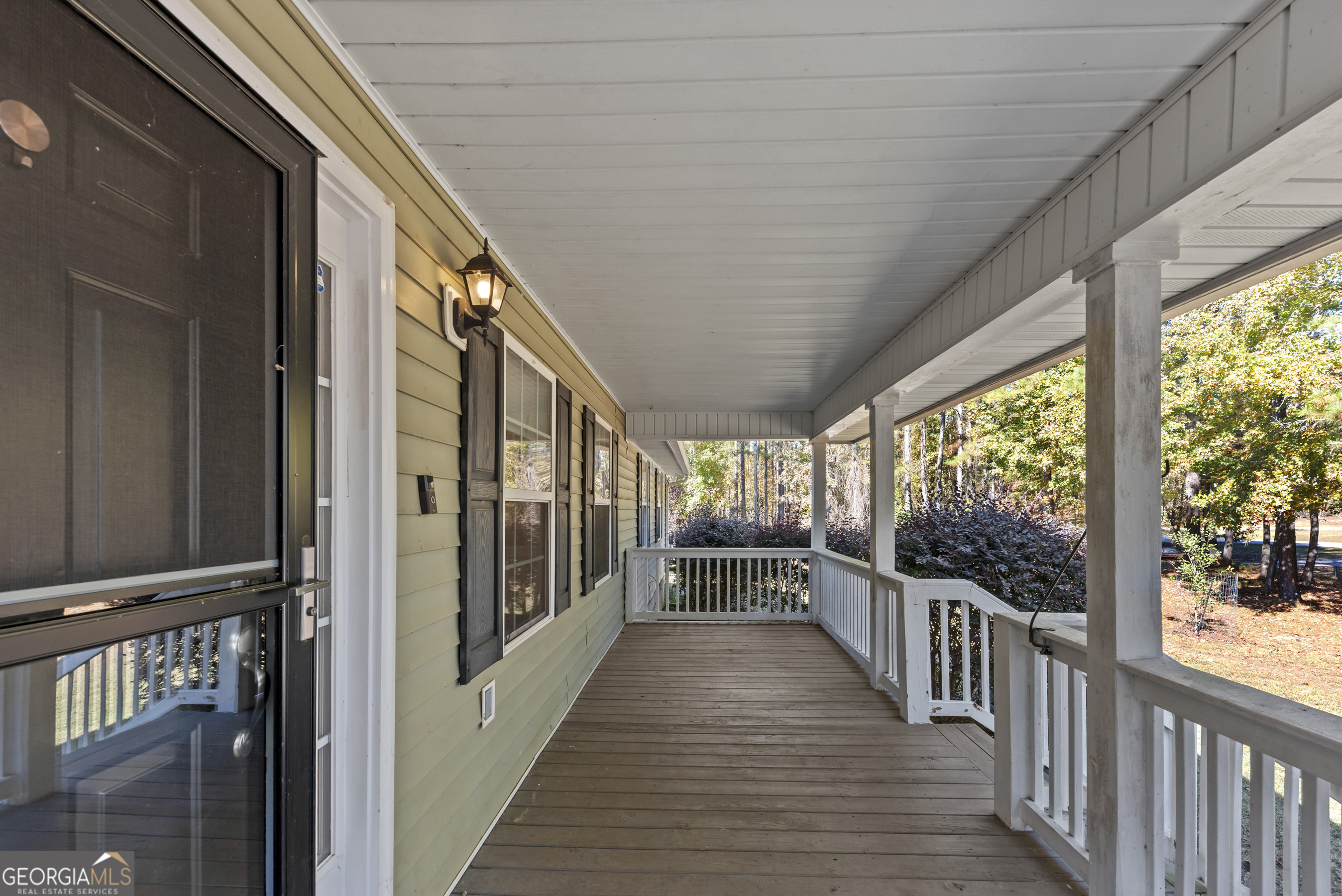384 Scuffleboro Road Southeast Eatonton, GA 31024 - Photo 5 of 48 a view of a porch with wooden floor and furniture