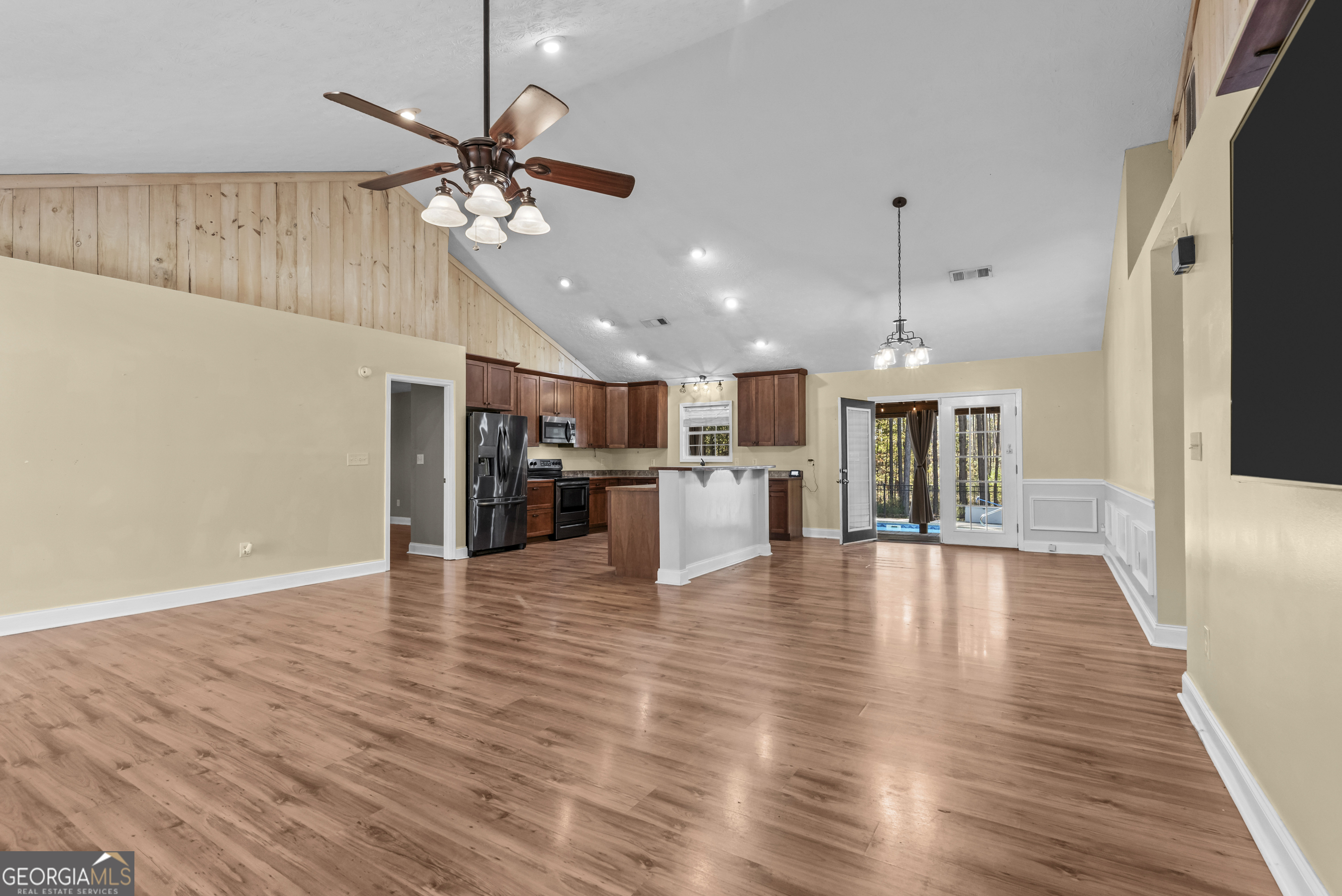 384 Scuffleboro Road Southeast Eatonton, GA 31024 - Photo 7 of 48 a view of an empty room with kitchen appliances and a ceiling fan