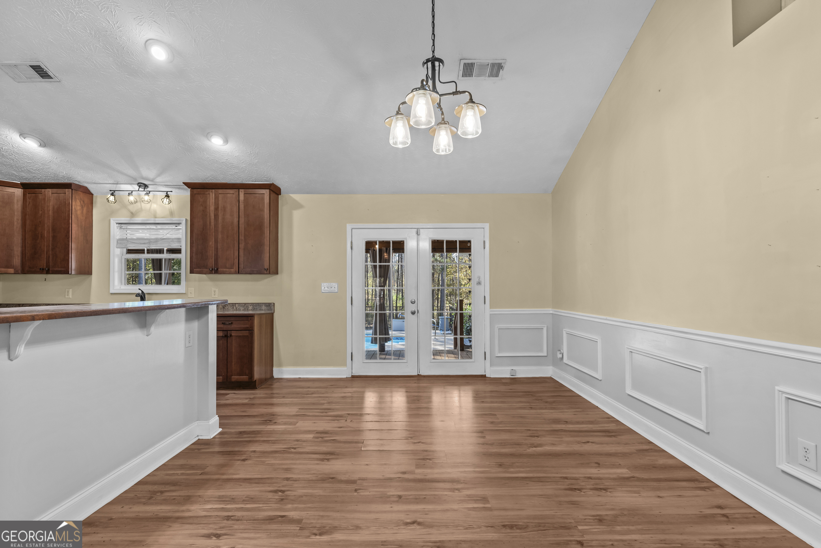 384 Scuffleboro Road Southeast Eatonton, GA 31024 - Photo 10 of 48 a view of a kitchen with a stove wooden cabinets and wooden floor