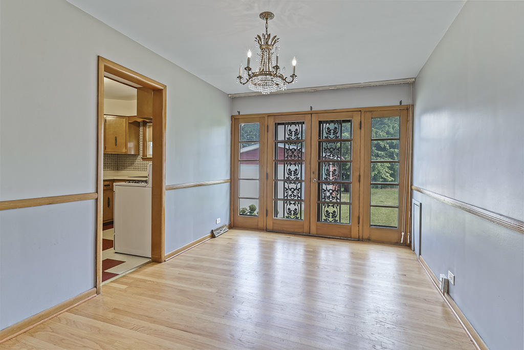 1120 183rd Street Homewood, IL 60430 - Photo 7 of 17 a view of an empty room with wooden floor and a window