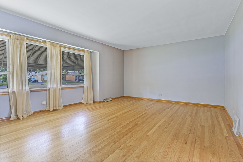 1120 183rd Street Homewood, IL 60430 - Photo 8 of 17 a view of an empty room with wooden floor and a window