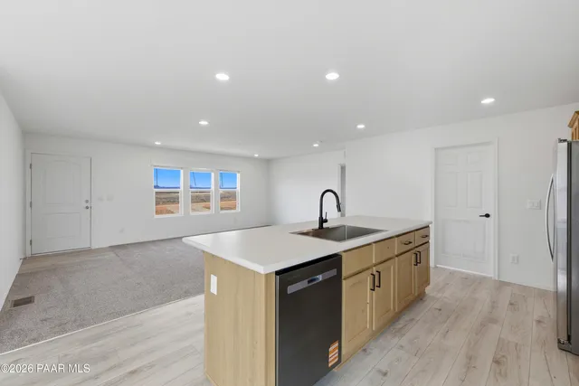 a kitchen with a sink a toilet and a large mirror