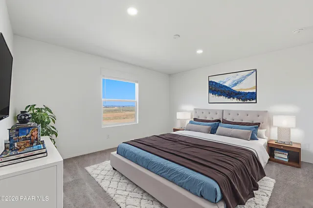 a bedroom with a bed and a painting on the wall