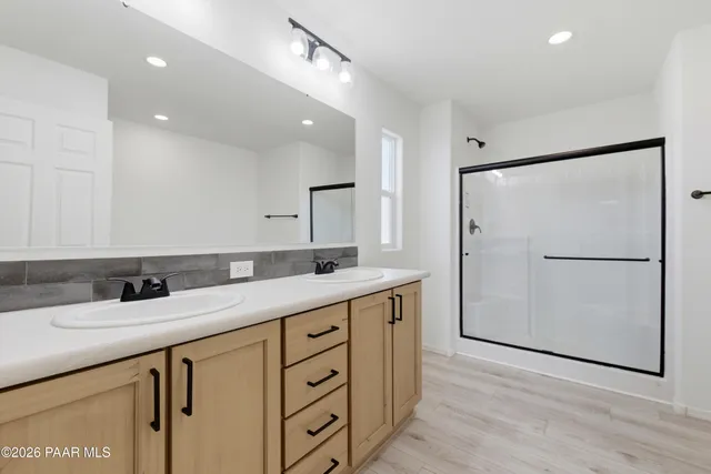 a bathroom with a double vanity sink and mirror