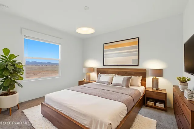 a bedroom with bed and window