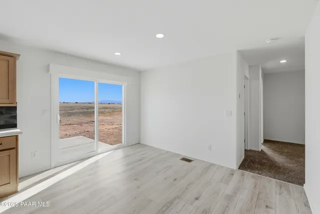 a view of wooden floor and windows in an empty room