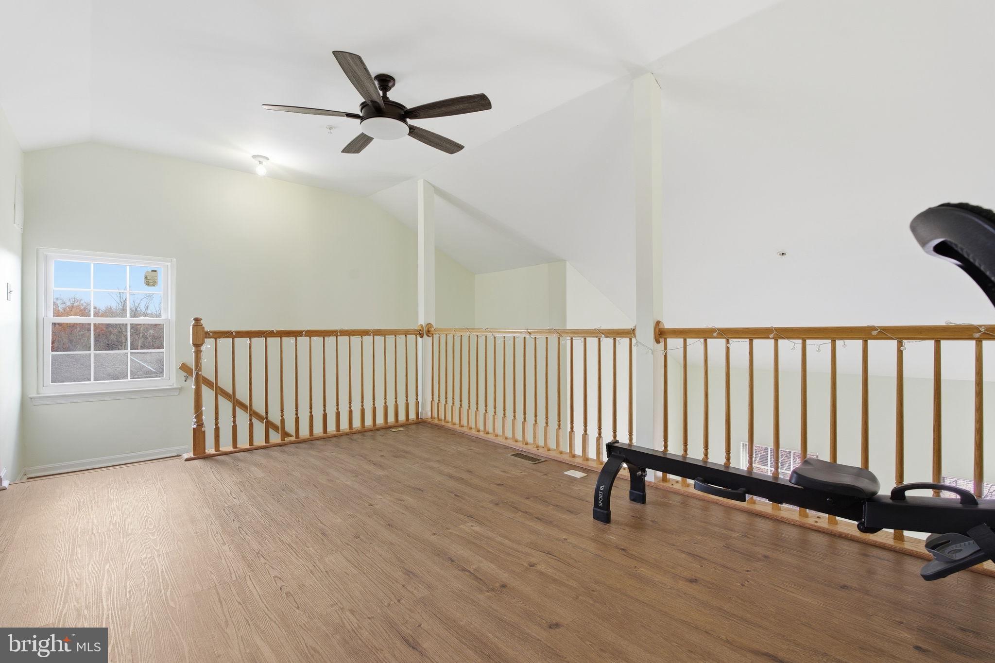 9300 Ridings Way Laurel, MD 20723 - Photo 11 of 24 an empty room with wooden floor and windows