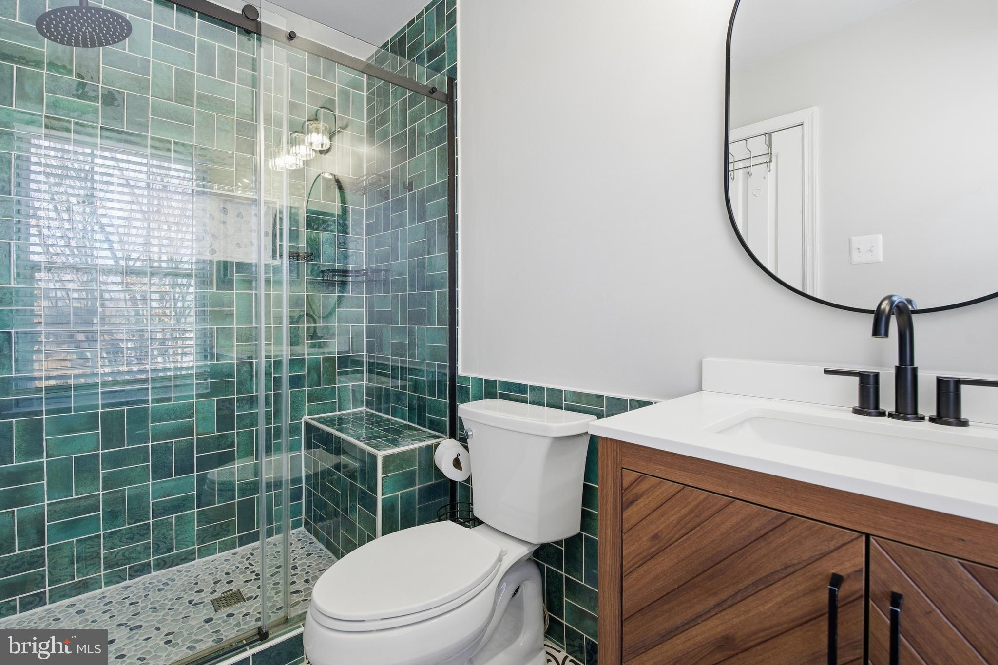 9300 Ridings Way Laurel, MD 20723 - Photo 12 of 24 a bathroom with a sink a toilet and shower