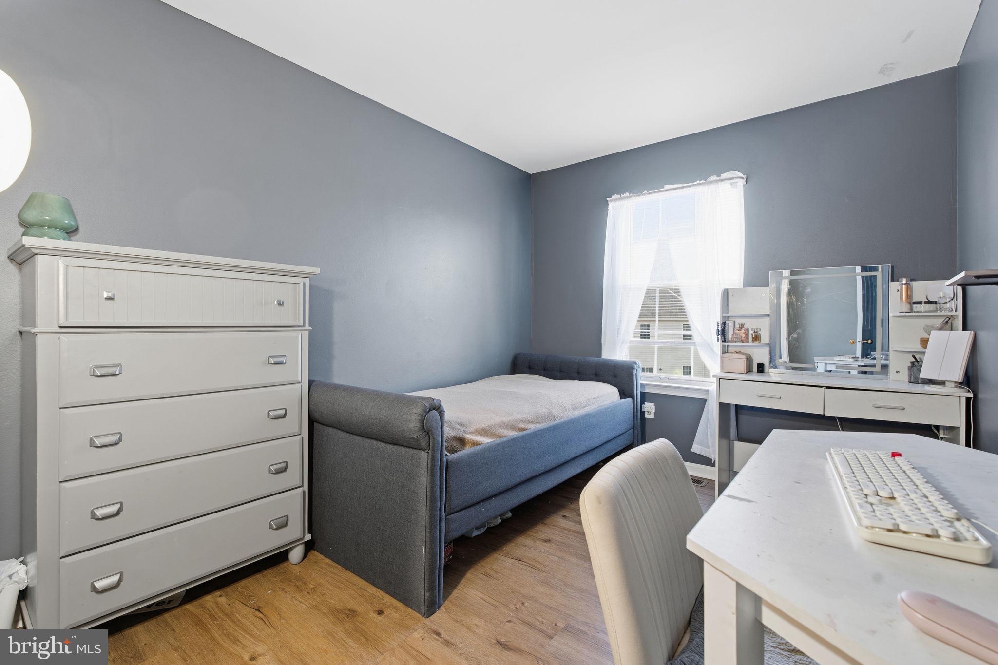 9300 Ridings Way Laurel, MD 20723 - Photo 13 of 24 a bedroom with a bed and a dresser