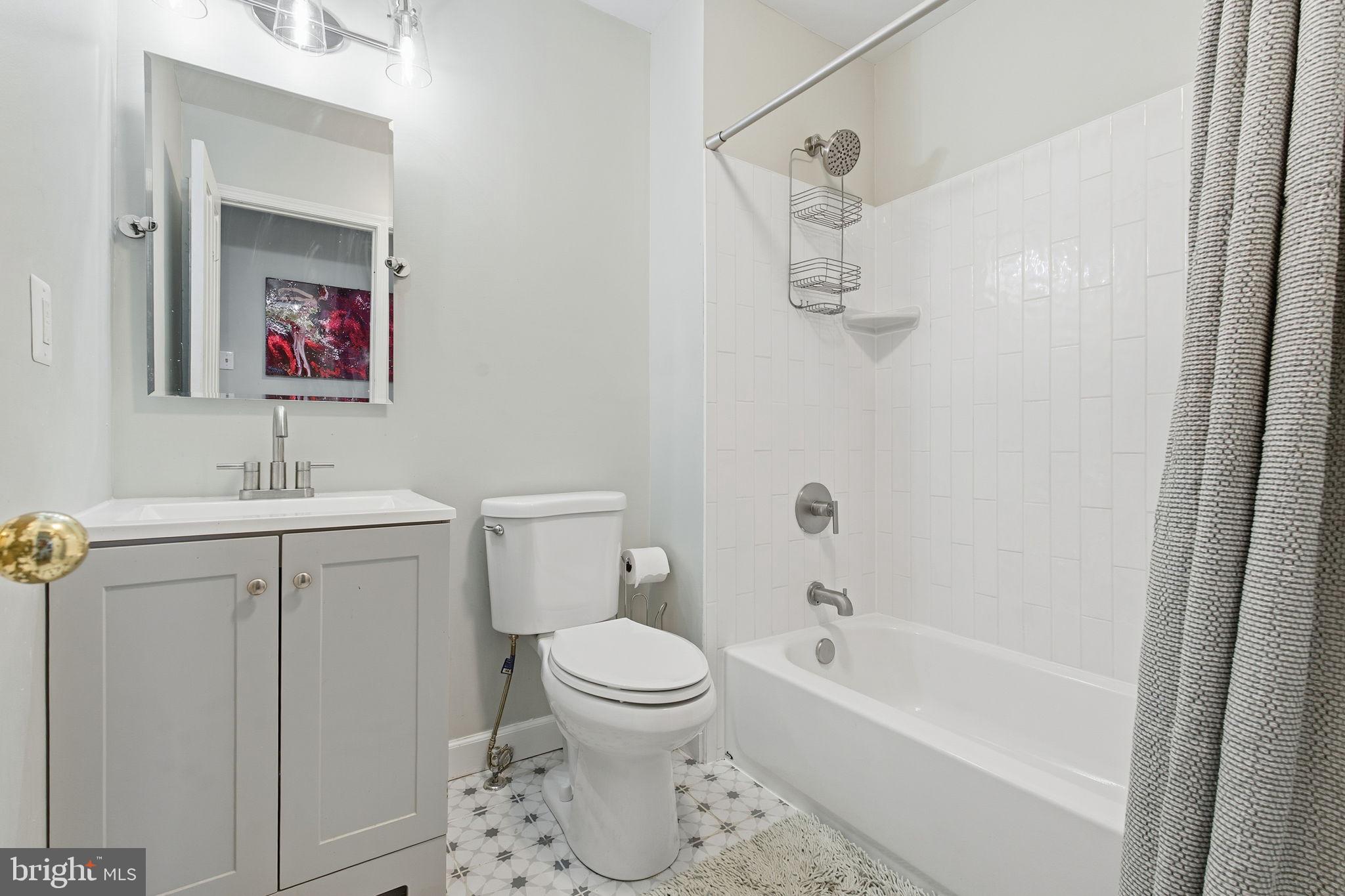 9300 Ridings Way Laurel, MD 20723 - Photo 14 of 24 a bathroom with a sink toilet and shower