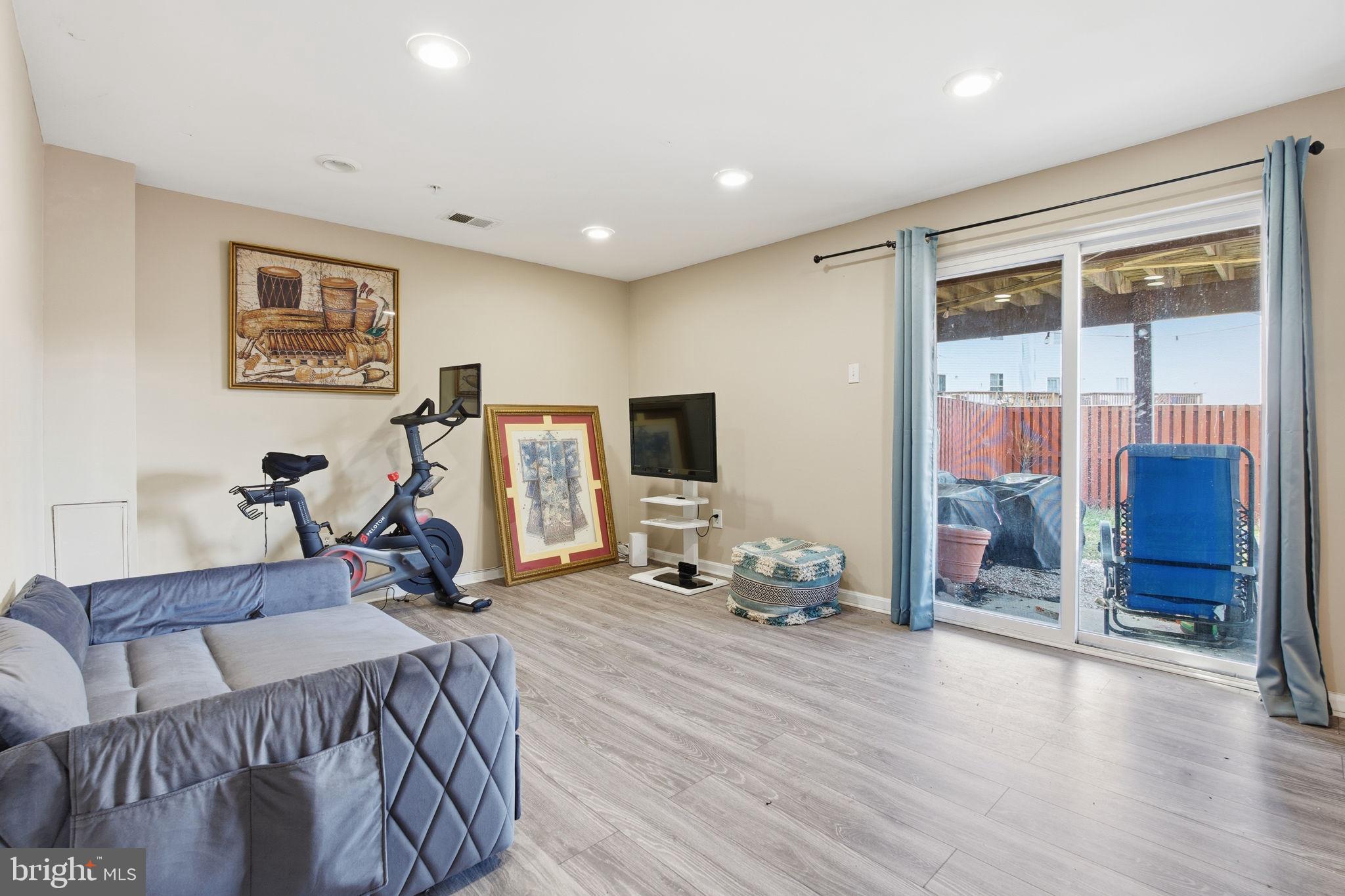 9300 Ridings Way Laurel, MD 20723 - Photo 16 of 24 a bed room with furniture and a flat screen tv