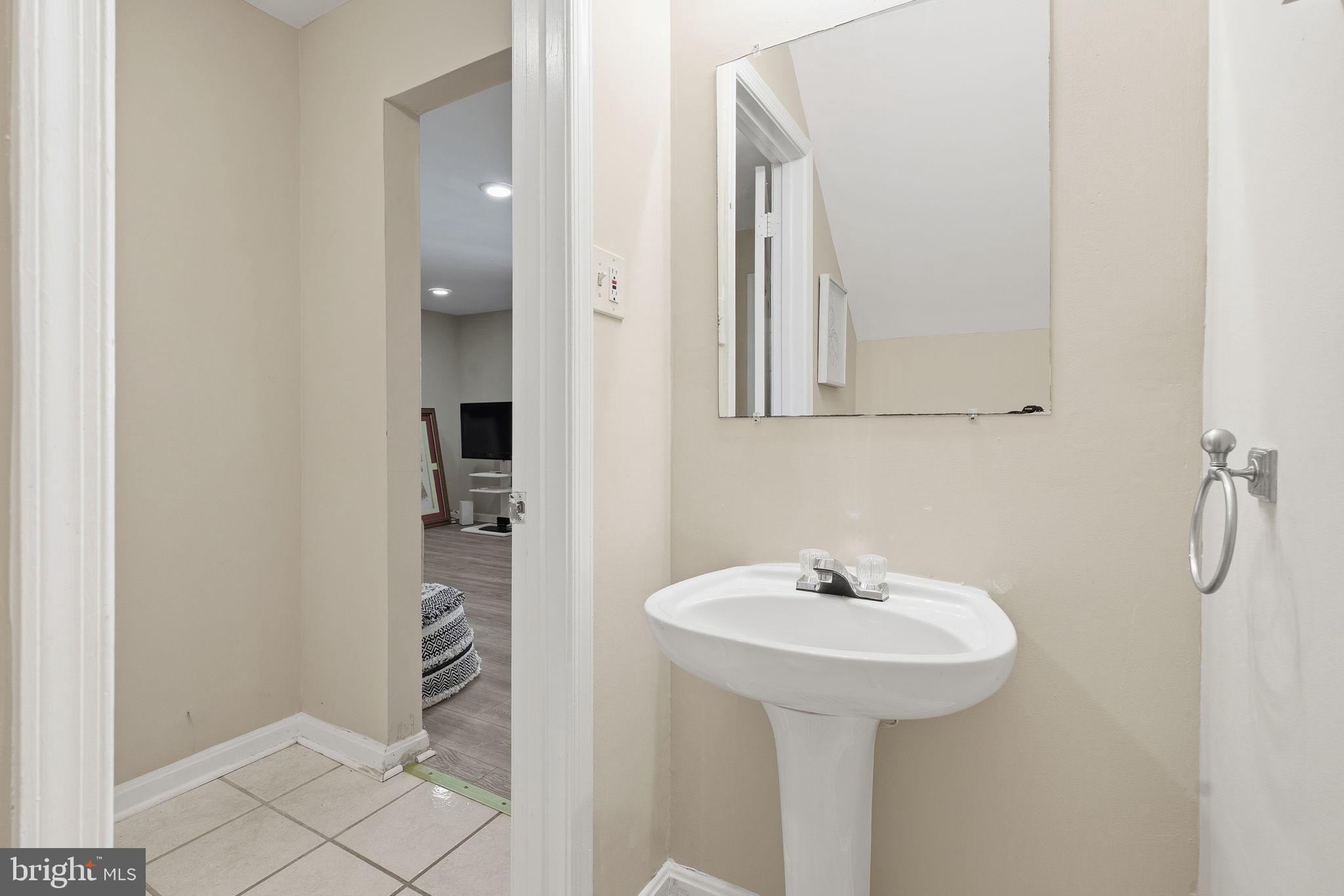 9300 Ridings Way Laurel, MD 20723 - Photo 17 of 24 a bathroom with a sink and a mirror