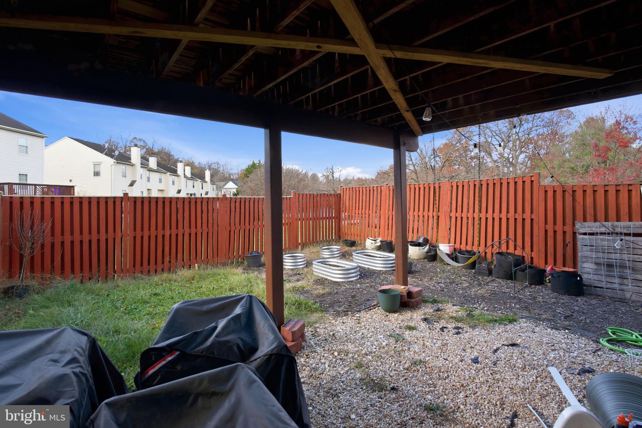 9300 Ridings Way Laurel, MD 20723 - Photo 19 of 24 a view of a patio with a table chairs and a patio