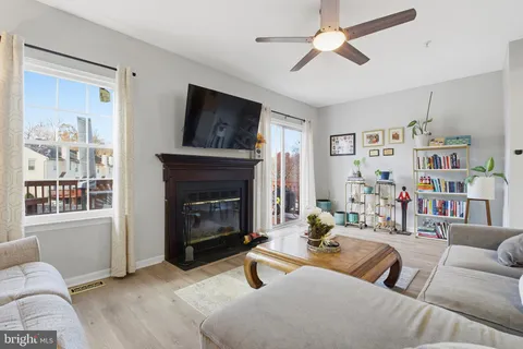 a living room with furniture a window and a fireplace