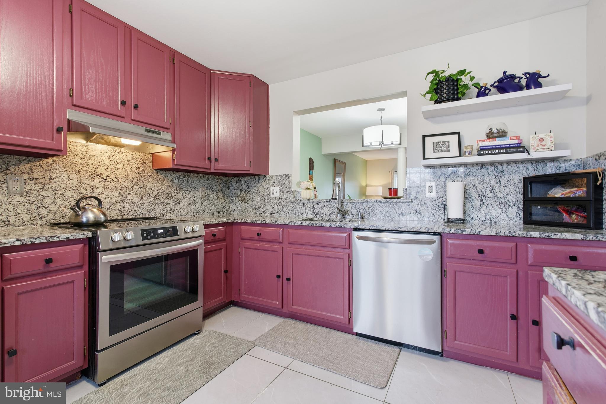 9300 Ridings Way Laurel, MD 20723 - Photo 6 of 24 a kitchen with granite countertop wooden cabinets and stainless steel appliances