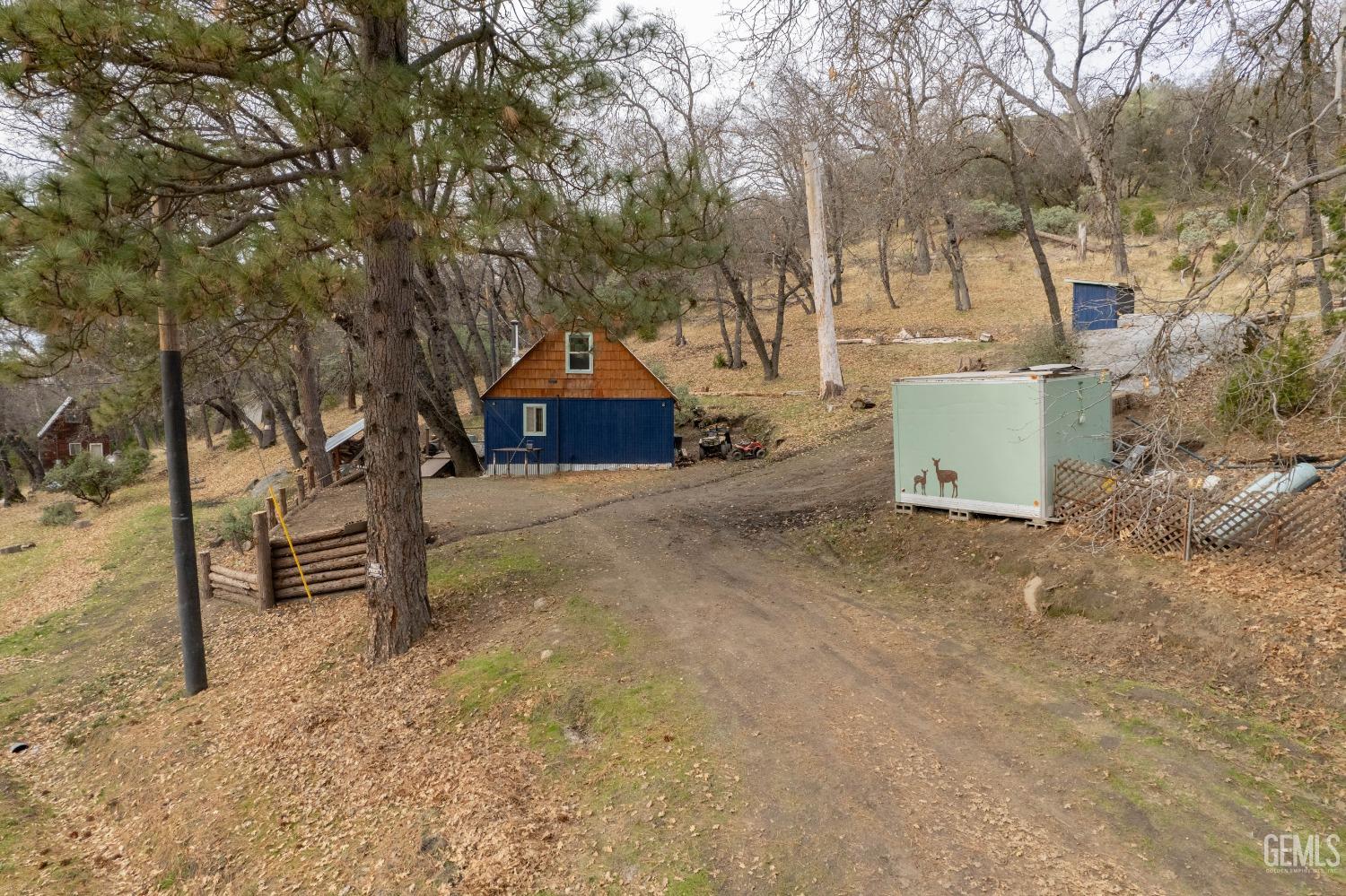 Undisclosed Address Posey, CA 93260 - Photo 11 of 51 a view of a house with a yard and garage